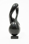 With its fluid and elegant lines, this abstract stone sculpture by Jeremy Guy appears to resemble a figure eight. Image 2