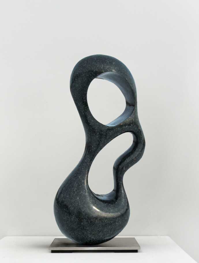 This contemporary abstract indoor sculpture is made from granite by Jeremy Guy.