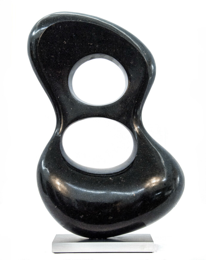 Smooth-surfaced, black granite has been engineered into an elegant figure eight shape by sculptor Jeremy Guy.