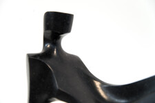This abstract figurative sculpture is made of engineered black granite by Jeremy Guy. Image 2