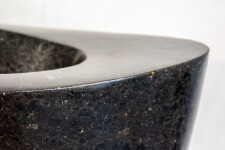 Smooth-surfaced, black granite flecked almost imperceptibly with copper and white has been engineered into an elegant ribbon in tangible con… Image 3