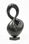 With its fluid and elegant lines, this abstract stone sculpture by Jeremy Guy appears to resemble a figure eight. Image 3