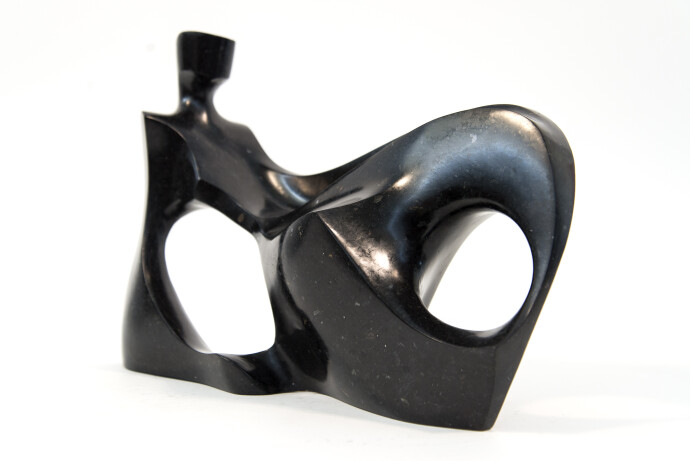 This abstract figurative sculpture is made of engineered black granite by Jeremy Guy.