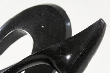 Smooth-surfaced, engineered black granite is sculpted into an elegant, spinning form by Jeremy Guy. Image 4