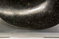 Smooth-surfaced, black granite flecked almost imperceptibly with copper and white has been engineered into an elegant ribbon in tangible con… Image 6