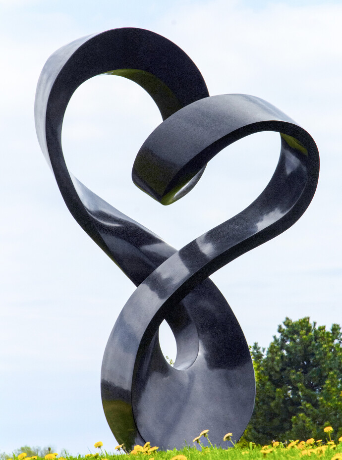Smooth black granite has been engineered to resemble a treble clef in this elegant outdoor sculpture by Canadian artist Jeremy Guy.