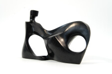 This abstract figurative sculpture is made of engineered black granite by Jeremy Guy. Image 5
