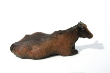 Charlot is a table-top sculpture of a regal adult female cow sitting, her beautiful face turned towards the viewer, legs tucked under her ma… Image 3