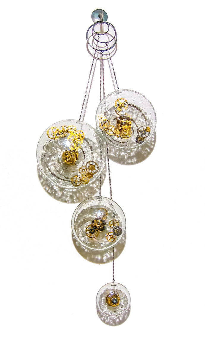 Four elegant blown glass orbs that contain assembled clock works hang from fine chain in this unique wall sculpture by John Paul Robinson.Th…