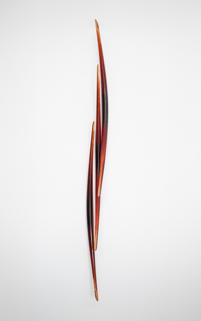 This modern glass wall sculpture in red was forged by John Paul Robinson.