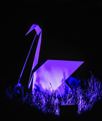 This contemporary metal garden sculpture is made in the form of a white swan.