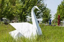 This contemporary metal garden sculpture is made in the form of a white swan. Image 8