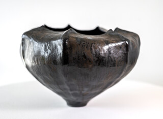 This contemporary ceramic black bowl is by Loren Kaplan.