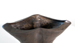 This contemporary ceramic black vessel in a floral shape is by Loren Kaplan. Image 7