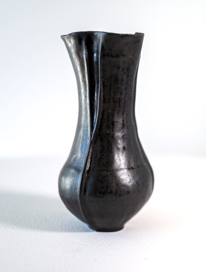 This contemporary ceramic black vase is by Loren Kaplan.