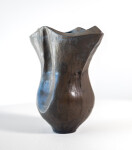 This contemporary ceramic black vessel in a floral shape is by Loren Kaplan. Image 2
