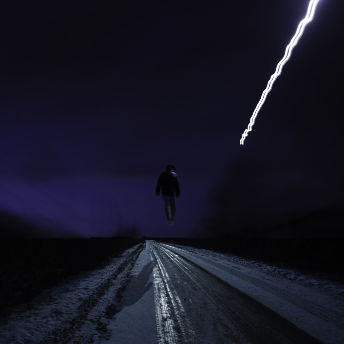 This contemporary photograph by Mark Bartkiw of a figure walking in the countryside in winter is surreal.