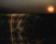A line of fiery orange splits a dark road in two in this dramatic image by Mark Bartkiw. Image 2