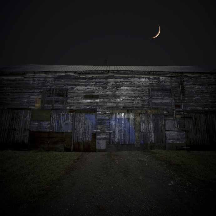 A moonlit barn glows in this emotive c-print by Mark Bartkiw.