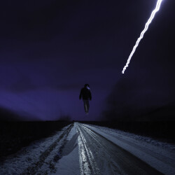 This contemporary photograph by Mark Bartkiw of a figure walking in the countryside in winter is surreal.