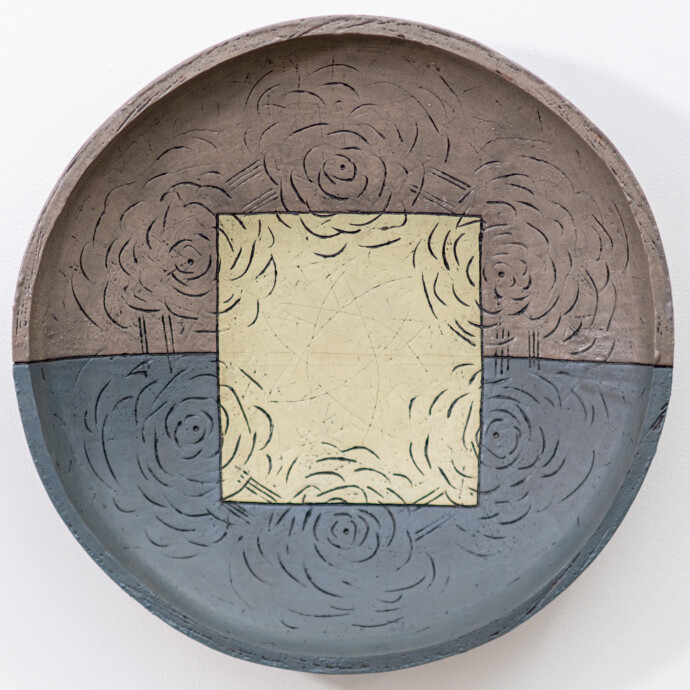 This contemporary wall sculpture is a handmade ceramic bowl.