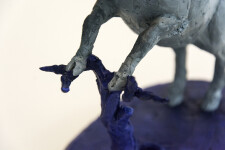 Cast in resin, a figurine of a boar posed on an indigo base points to a theme of human and animal interaction that includes taxidermy. Image 3