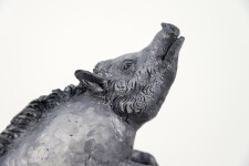 Cast in resin, a figurine of a boar posed on an indigo base points to a theme of human and animal interaction that includes taxidermy. Image 7