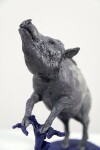 Cast in resin, a figurine of a boar posed on an indigo base points to a theme of human and animal interaction that includes taxidermy. Image 2