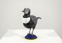 Cast in resin, a figurine of a pheasant posed on an indigo base points to a theme of human and animal interaction. Image 4