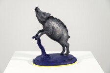 Cast in resin, a figurine of a boar posed on an indigo base points to a theme of human and animal interaction that includes taxidermy. Image 6