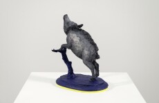 Cast in resin, a figurine of a boar posed on an indigo base points to a theme of human and animal interaction that includes taxidermy. Image 5