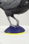 Cast in resin, a figurine of a pheasant posed on an indigo base points to a theme of human and animal interaction. Image 8