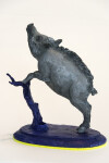 Cast in resin, a figurine of a boar posed on an indigo base points to a theme of human and animal interaction that includes taxidermy. Image 2