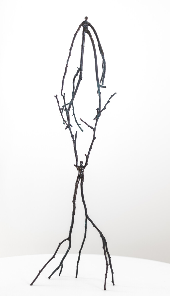 This contemporary figurative tabletop sculpture is forged in bronze.