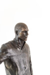 This indoor table top figurative sculpture of a male is cast in bronze. Image 10