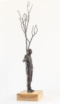 This indoor table top figurative sculpture of a male is cast in bronze. Image 4