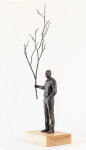This indoor table top figurative sculpture of a male is cast in bronze. Image 2