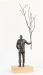 This indoor table top figurative sculpture of a male is cast in bronze. Image 3