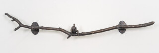This contemporary indoor bronze figurative sculpture of a male is designed to be mounted on the wall.