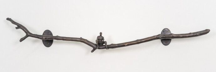 This contemporary indoor bronze figurative sculpture of a male is designed to be mounted on the wall.