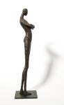 He stands tall—a slender naked figure, arms crossed, head slightly tilted. Image 3