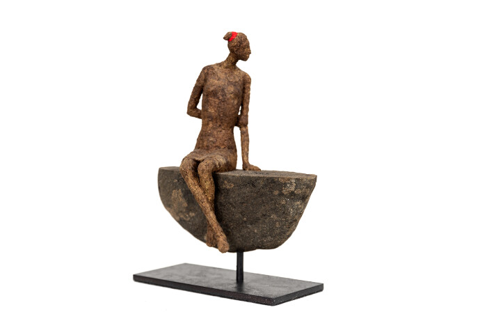 This contemporary figurative female table top sculpture is made from papier mâché.