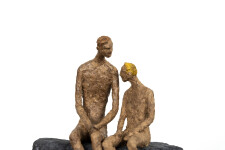 This contemporary figurative table top sculpture of a father and son is created from papier mâché. Image 2