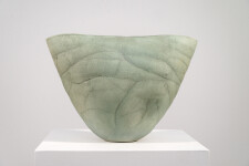 This contemporary ceramic vessel is moss green in color. Image 9