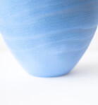 This contemporary blue ceramic vase has an organic shape inspired by nature. Image 5