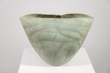 This contemporary ceramic vessel is moss green in color. Image 8