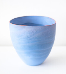 This contemporary blue ceramic vase has an organic shape inspired by nature.
