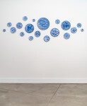 This contemporary horizontal wall composition by Paula Murray is composed of blue porcelain discs. Image 2