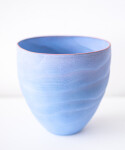 This contemporary blue ceramic vase has an organic shape inspired by nature. Image 3