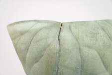 This contemporary ceramic vessel is moss green in color. Image 11